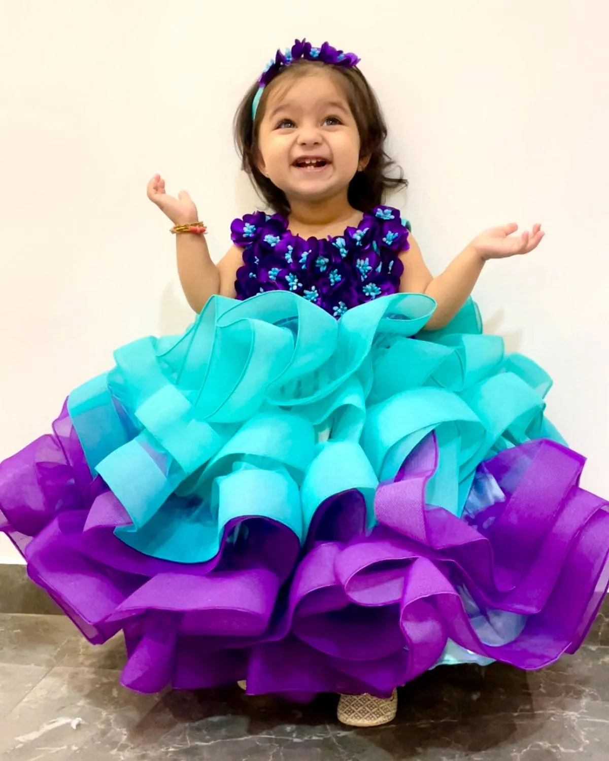 Pre-Order: Aqua Blue And Purple Gown With Fluffy Layered Netted Bottom And Hand-Crafted Purple Flowers